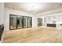 Spacious living room with hardwood floors and glass doors leading to the backyard at 4550 Jolyn Pl, Sandy Springs, GA 30342