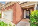 Inviting entryway with a black door, brick accents, and a well-maintained lawn at 137 Staley Dr, Tucker, GA 30084