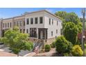 Attractive townhome exhibiting a white painted brick, covered porch, stone foundation, and a manicured lawn at 210 Marjean Way, Alpharetta, GA 30009