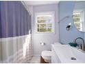 Bright bathroom features a blue accented wall, modern fixtures and bathtub with shower at 2785 Toney Dr, Decatur, GA 30032