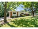 Beautiful home exterior on a large lot with mature trees and green grass at 2785 Toney Dr, Decatur, GA 30032