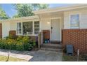 Charming front porch with brick accents and lush landscaping surrounding the entrance at 2785 Toney Dr, Decatur, GA 30032