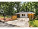 A single-story home with a well-kept lawn, driveway, and a wooden fence at 435 Mcwilliams Se Ave, Atlanta, GA 30316