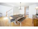 Dining room featuring hardwood floors, a chandelier, and a view to the stairs and kitchen at 503 Hearthstone Rdg, Woodstock, GA 30189