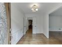 Inviting foyer with hardwood floors, detailed trim, and elegant lighting fixture at 7660 Dunvegan Close, Sandy Springs, GA 30350