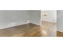 Bright living room with hardwood floors and decorative wall trim at 7660 Dunvegan Close, Sandy Springs, GA 30350