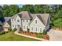 Beautiful two-story home with a well-maintained lawn and a classic architectural design at 3330 Arborwoods Dr, Alpharetta, GA 30022