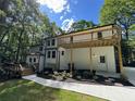 Back exterior view of the home featuring a wooden deck and outdoor space at 3820 Fox Creek Ct, Marietta, GA 30062