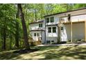 Exterior of home showcasing the side yard, rear deck, and mature trees at 3820 Fox Creek Ct, Marietta, GA 30062