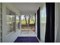 Cozy screened porch with a blue rug, a view of the backyard, and blue curtains at 4682 Stonewall Tell Rd, College Park, GA 30349