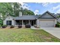 Charming single-story home with gray brick, manicured landscaping, and a two-car garage at 179 Carter Rd, Auburn, GA 30011