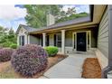 Inviting covered porch with decorative columns and a modern front door at 179 Carter Rd, Auburn, GA 30011