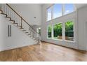 Bright entryway features hardwood floors, a staircase, and a view to the backyard through large windows at 2310 Norbury Se Cv, Smyrna, GA 30080