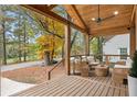Inviting covered front porch with outdoor seating, wooden beams, and an outdoor ceiling fan at 410 Wilkinson Se Dr, Atlanta, GA 30317
