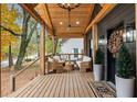 Cozy covered front porch with wooden beams, stylish seating, plants, and a ceiling fan at 410 Wilkinson Se Dr, Atlanta, GA 30317
