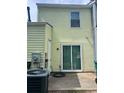 Rear exterior featuring siding, sliding glass doors to the patio, and an air conditioning unit at 458 Prince Of Wales, Stone Mountain, GA 30083