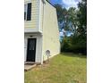 Side view of the home with a well kept lawn and external antenna at 458 Prince Of Wales, Stone Mountain, GA 30083