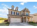 Charming two-story home featuring a brick facade, siding accents, and a spacious two-car garage at 109 Logan Pass Dr, Loganville, GA 30052