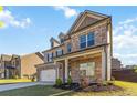 Attractive two-story home with a well-kept lawn, brick accents, and attached two-car garage at 109 Logan Pass Dr, Loganville, GA 30052