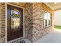 Close-up of the home's entrance highlighting the brickwork, stylish door, and welcoming wreath at 109 Logan Pass Dr, Loganville, GA 30052