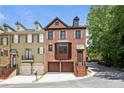 Stunning brick townhouse with a two-car garage, bay window, and elegant curb appeal at 1605 Pavillion Ridge Se Dr, Smyrna, GA 30080