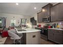 Well-equipped kitchen featuring stainless steel appliances, a spacious island, and stylish barstool seating at 1296 Taylor Way, Stone Mountain, GA 30083