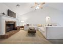 Cozy living room showcasing a brick fireplace, plush sofa, and high ceilings at 173 Kingswood Dr, Ellenwood, GA 30294