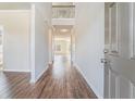 Inviting hallway with hardwood floors, high ceilings, and neutral paint, offering a bright and open entryway at 2349 Hanover Woods Rd, Lithonia, GA 30058