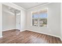 Bright living room features hardwood floors, large windows, and fresh paint, ready for your personal touch at 2349 Hanover Woods Rd, Lithonia, GA 30058