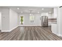 Spacious living area with wood floors, a back door view, and stainless steel kitchen appliances at 313 Yancy Se Dr, Marietta, GA 30067