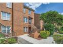 Well-maintained brick townhouse with landscaped front yard, offering a warm and inviting entrance at 91 Davis Mill Ct, Lawrenceville, GA 30044
