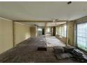 Spacious living room needing renovation with original wood floors and large windows for ample natural light at 1417 Richland Rd, Atlanta, GA 30310