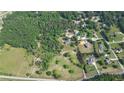 Aerial view of the property boundaries featuring a home, mature trees, and large grassy field in a rural setting at 2100 Highway 138 E E, Stockbridge, GA 30281