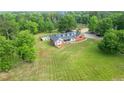 Aerial view of house featuring a pool and large manicured lawn surrounded by mature trees at 2100 Highway 138 E E, Stockbridge, GA 30281