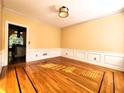 Elegant dining room boasting hardwood floors, wainscoting, and neutral paint at 1225 Creek Laurel Dr, Lawrenceville, GA 30043