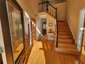Inviting foyer with hardwood floors, staircase, and decorative glass front door at 1225 Creek Laurel Dr, Lawrenceville, GA 30043