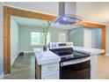Open concept kitchen and living room with wood accents and modern appliances at 3627 Groovers Lake Rd, Lithia Springs, GA 30122