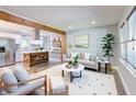 Open-concept living space boasts a modern design with hardwood floors, a plush sofa, and seamless flow into the kitchen at 3627 Groovers Lake Rd, Lithia Springs, GA 30122