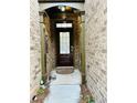 Front entrance featuring a brick facade, covered porch, and decorative accents at 4260 Hammond Bridge Dr, Suwanee, GA 30024