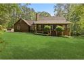 Charming home with a cozy front porch, nestled on a green lot with mature trees at 4615 Gresham Rd, Douglasville, GA 30134
