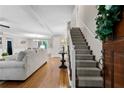 Spacious living room with staircase and hardwood floors seamlessly connects to the dining area at 4615 Gresham Rd, Douglasville, GA 30134