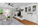 Inviting living room features a white fireplace and built-in cabinets for storage at 4615 Gresham Rd, Douglasville, GA 30134