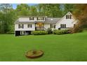 Spacious two-story home boasting a sprawling green lawn, black and white trim, and a private backyard at 4615 Gresham Rd, Douglasville, GA 30134