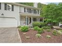 Well-maintained two-story home with lovely landscaping in the front yard at 120 Park Bridge Ln, Roswell, GA 30075