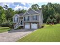 Inviting two-story home with stone accents, gray siding, well-kept lawn, and a convenient two-car garage at 20 Spruce Ne St, White, GA 30184