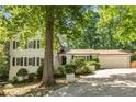 Beautiful home with a well-maintained lawn, mature trees, and inviting curb appeal at 3307 Pointe Bleue Ct, Decatur, GA 30034