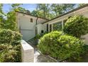 Home exterior with lush greenery, a charming entrance, and beautiful architectural details at 3307 Pointe Bleue Ct, Decatur, GA 30034