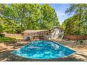 Inviting backyard featuring a sparkling pool, deck, and ample seating for outdoor entertaining at 3307 Pointe Bleue Ct, Decatur, GA 30034