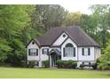 Charming two-story home with well-maintained lawn and mature landscaping in a wooded setting at 5022 Cliff Top Dr, Loganville, GA 30052