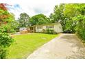 Charming single-Gathering home with a spacious front yard and ample parking space on driveway at 1303 Cochise Cir, Austell, GA 30168